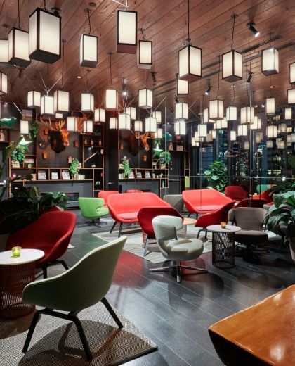 cosy furniture and bright lanterns at nighttime at cloudM rooftop bar of citizenM New York hotel